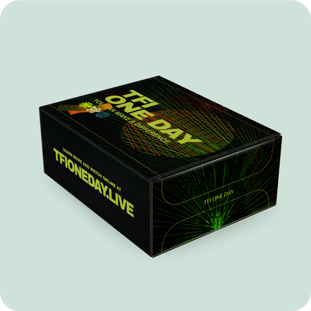 The TFI One Day mailer box in black with green light artwork