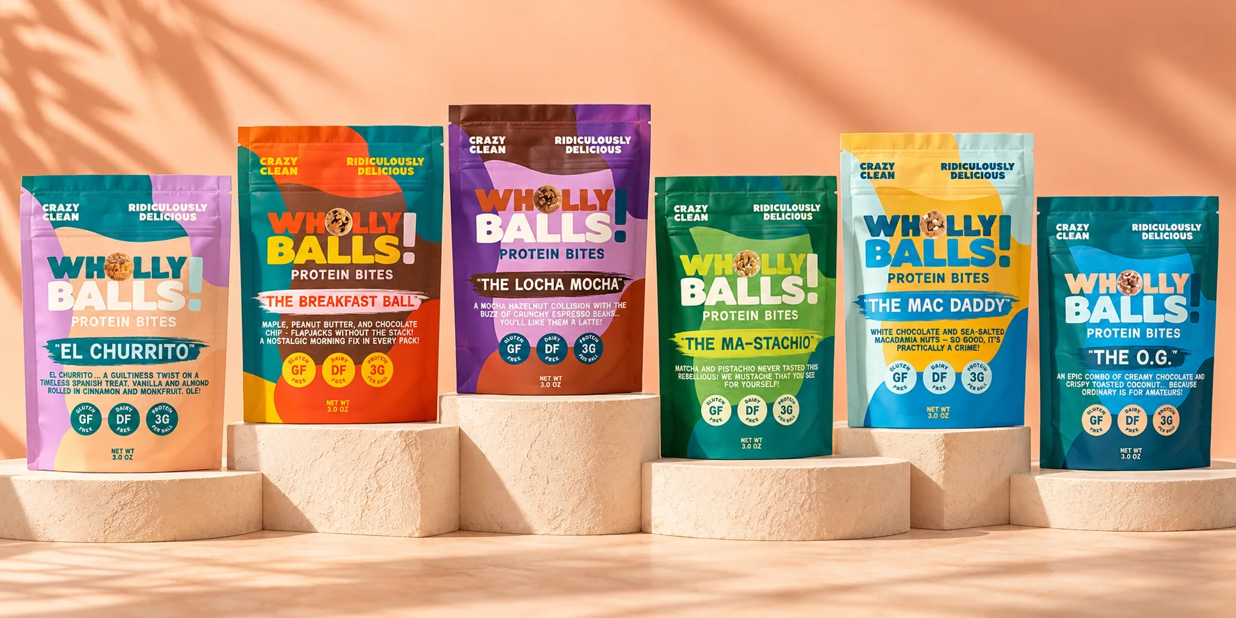 All six Wholly Balls flavors standing on stone plinths: El Churrito, The Breakfast Ball, The Locha Mocha, The Ma-Stachio, The Mac Daddy and The O.G.
